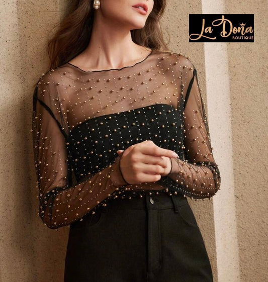 Blusa transparente con perlas doradas