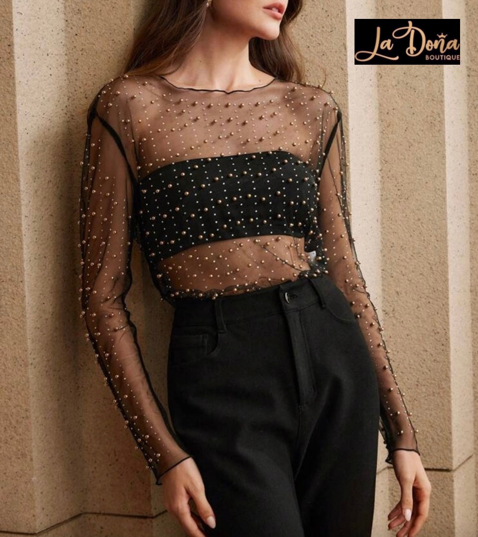 Blusa transparente con perlas doradas